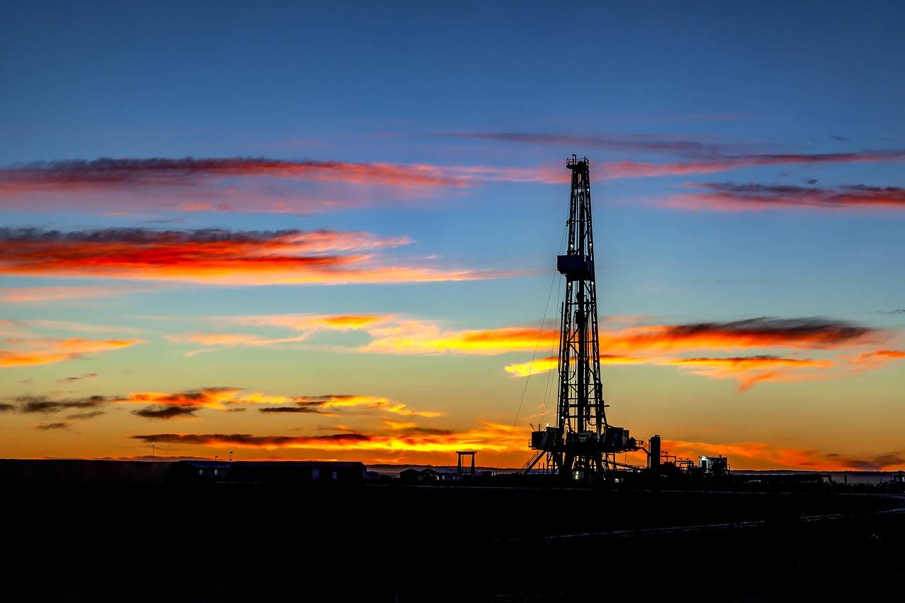 Oil and gas drilling rig at sunset